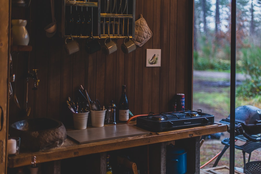 a kitchen with a stove top oven sitting on top of a wooden table