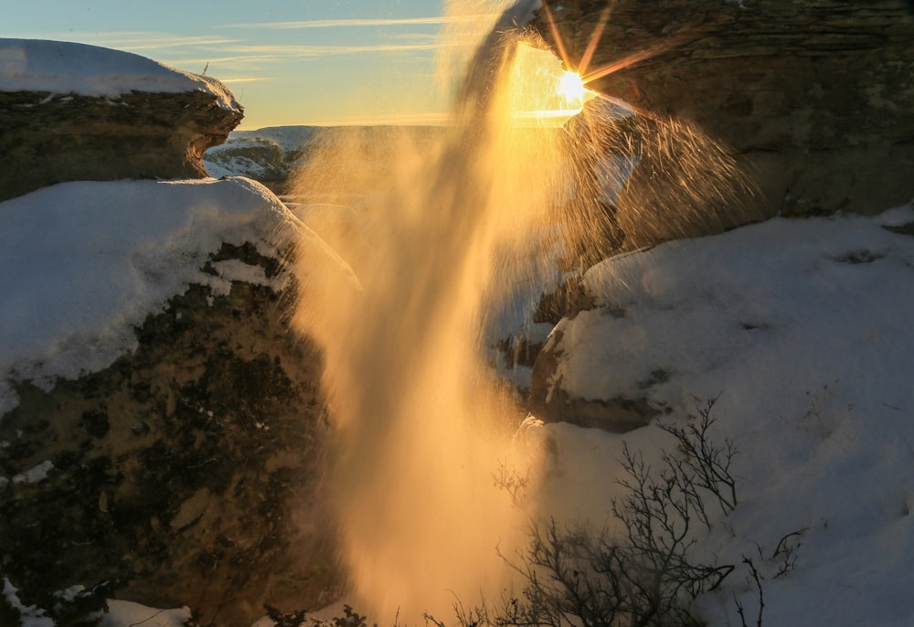 the sun shines through a hole in the snow