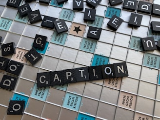 a close up of a scrabble tile wall with caption written on it