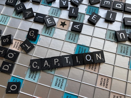 a close up of a scrabble tile wall with caption written on it