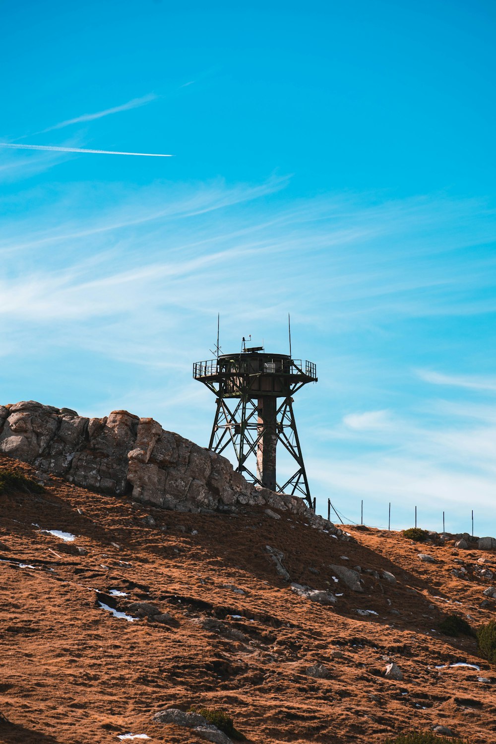 a tower on top of a hill with a sky background