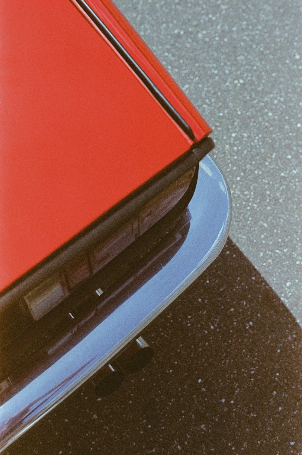 a close up of a red car's hood