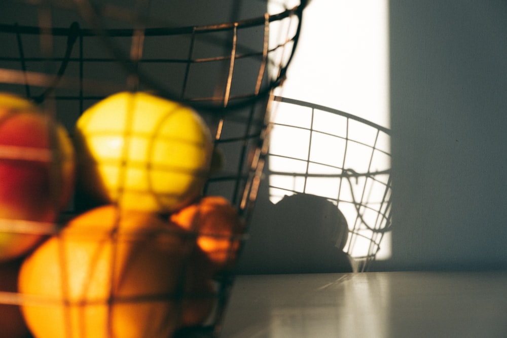 a basket full of apples and oranges on a table