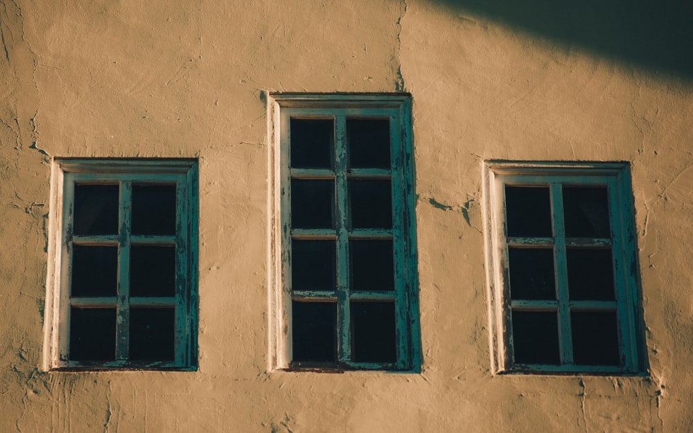 two windows on the side of a building