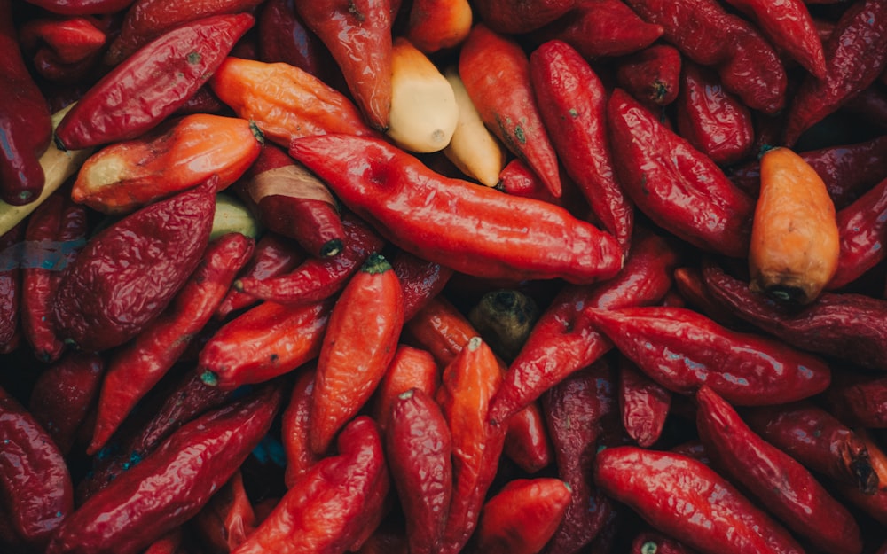 a pile of red peppers and other vegetables