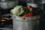 a pot filled with lots of vegetables on top of a stove