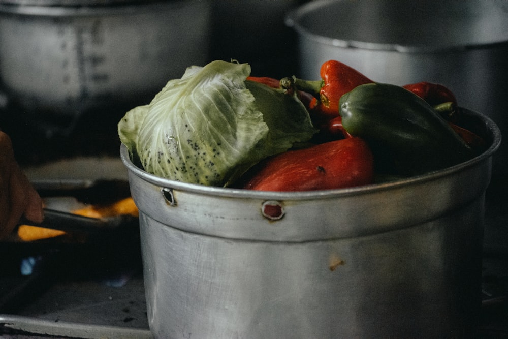 a pot filled with lots of vegetables on top of a stove