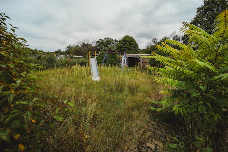 a grassy field with a white object in the middle of it
