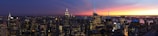 Panoramic view of a financial district skyline at twilight.