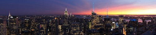 Panoramic view of a financial district skyline at twilight.