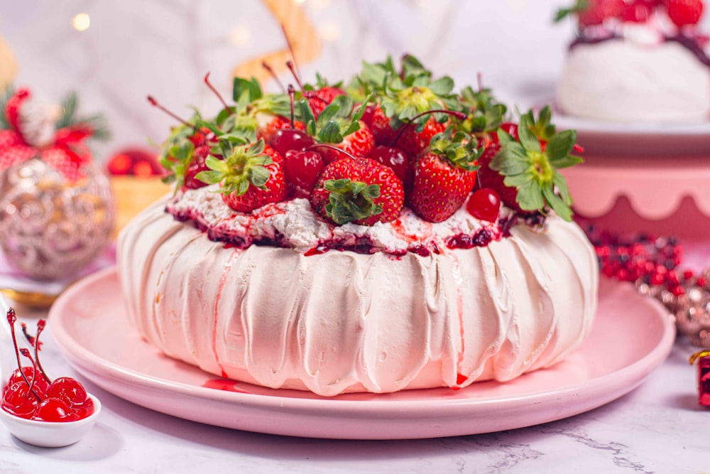 a cake with white frosting and strawberries on top