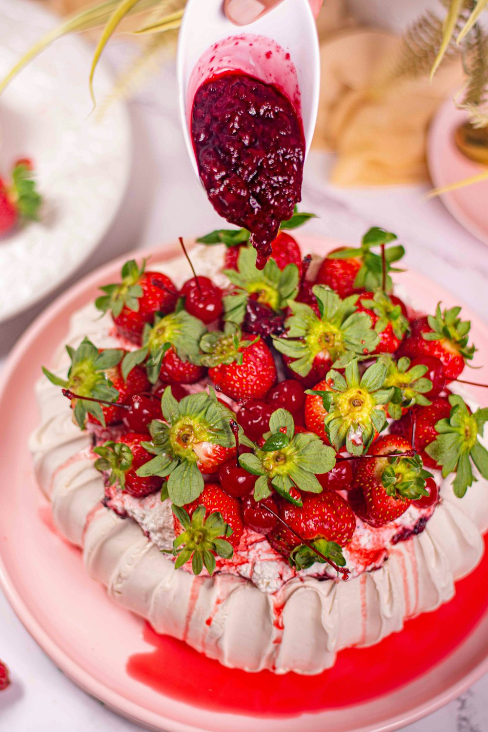 a strawberry cake is being drizzled with strawberry sauce