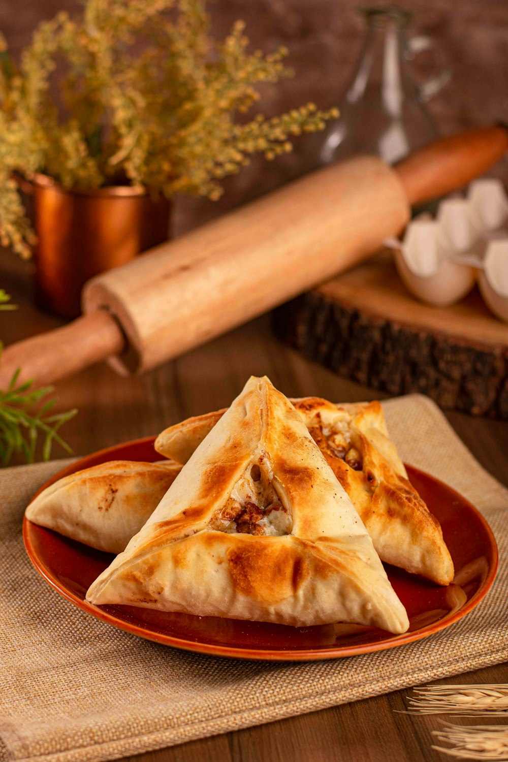 a plate of food on a table with a rolling pin