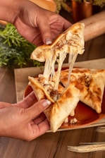 a slice of pizza being lifted from a plate