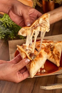 a slice of pizza being lifted from a plate