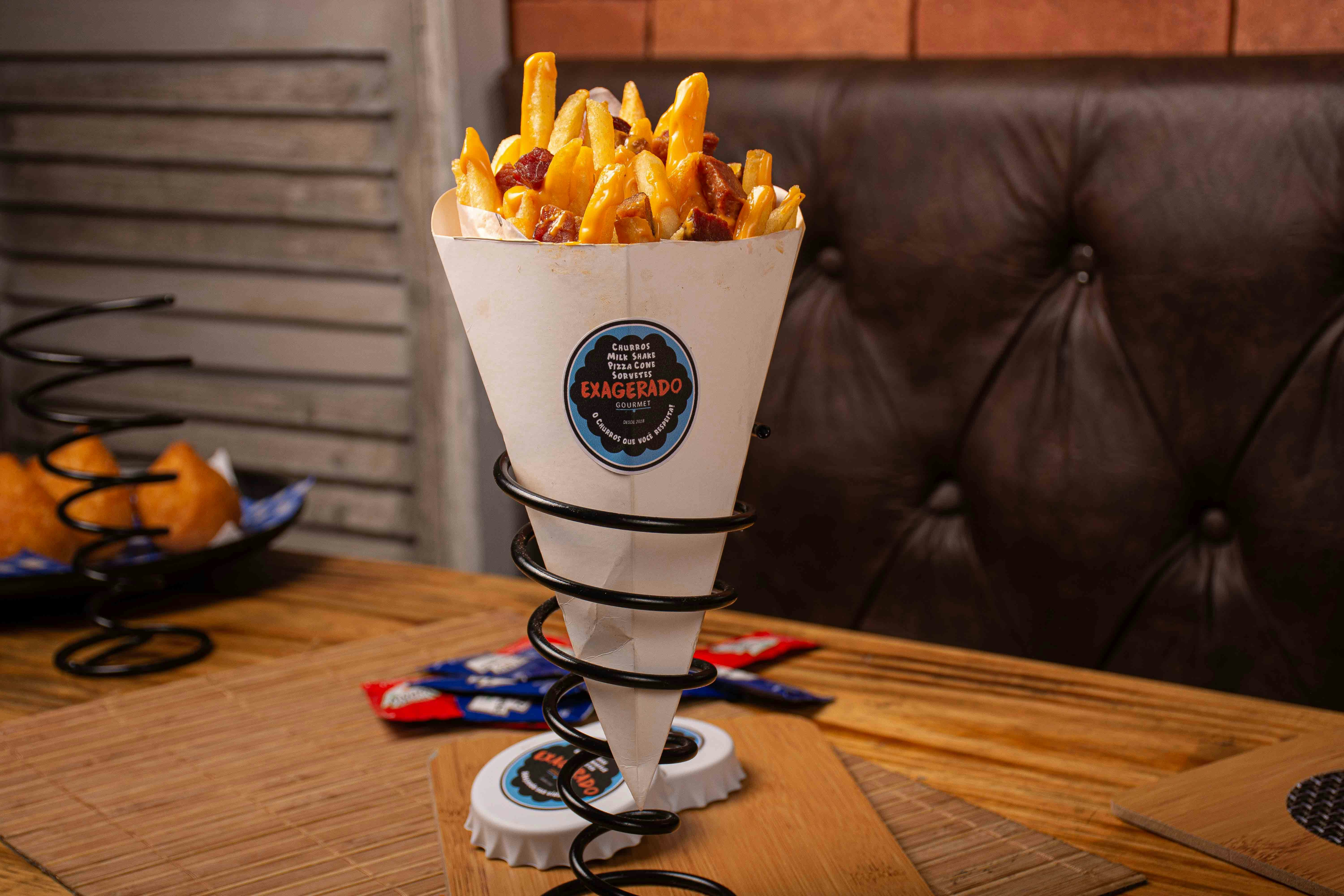 Loaded fries topped with melted cheese and toppings in bowl