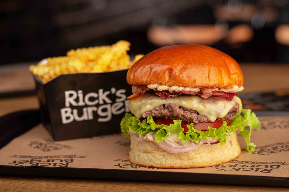 a cheeseburger with a side of fries on a tray