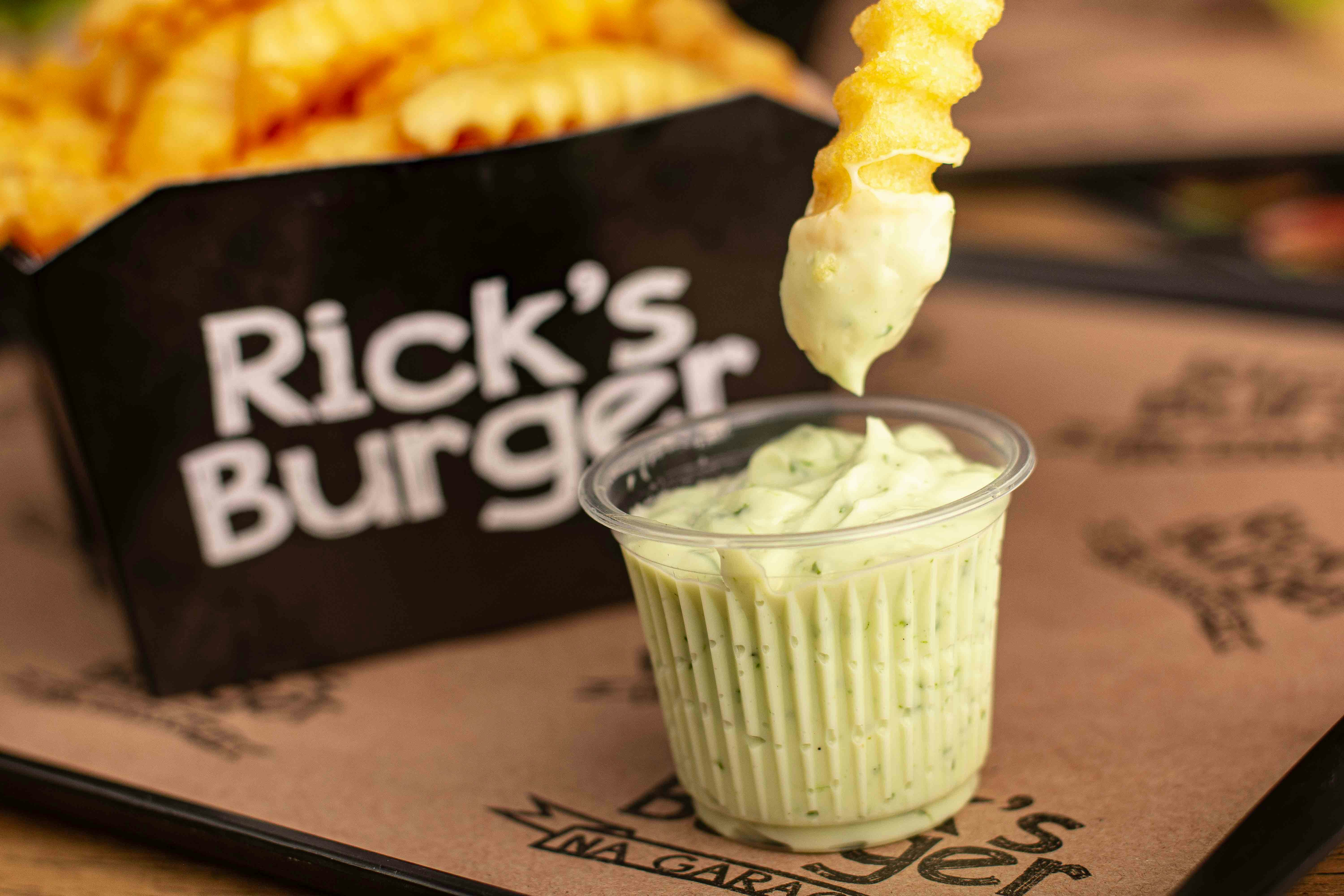 a person dipping some kind of food into a cup