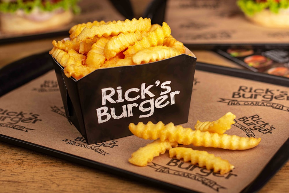 a tray with a bag of fries sitting on top of it