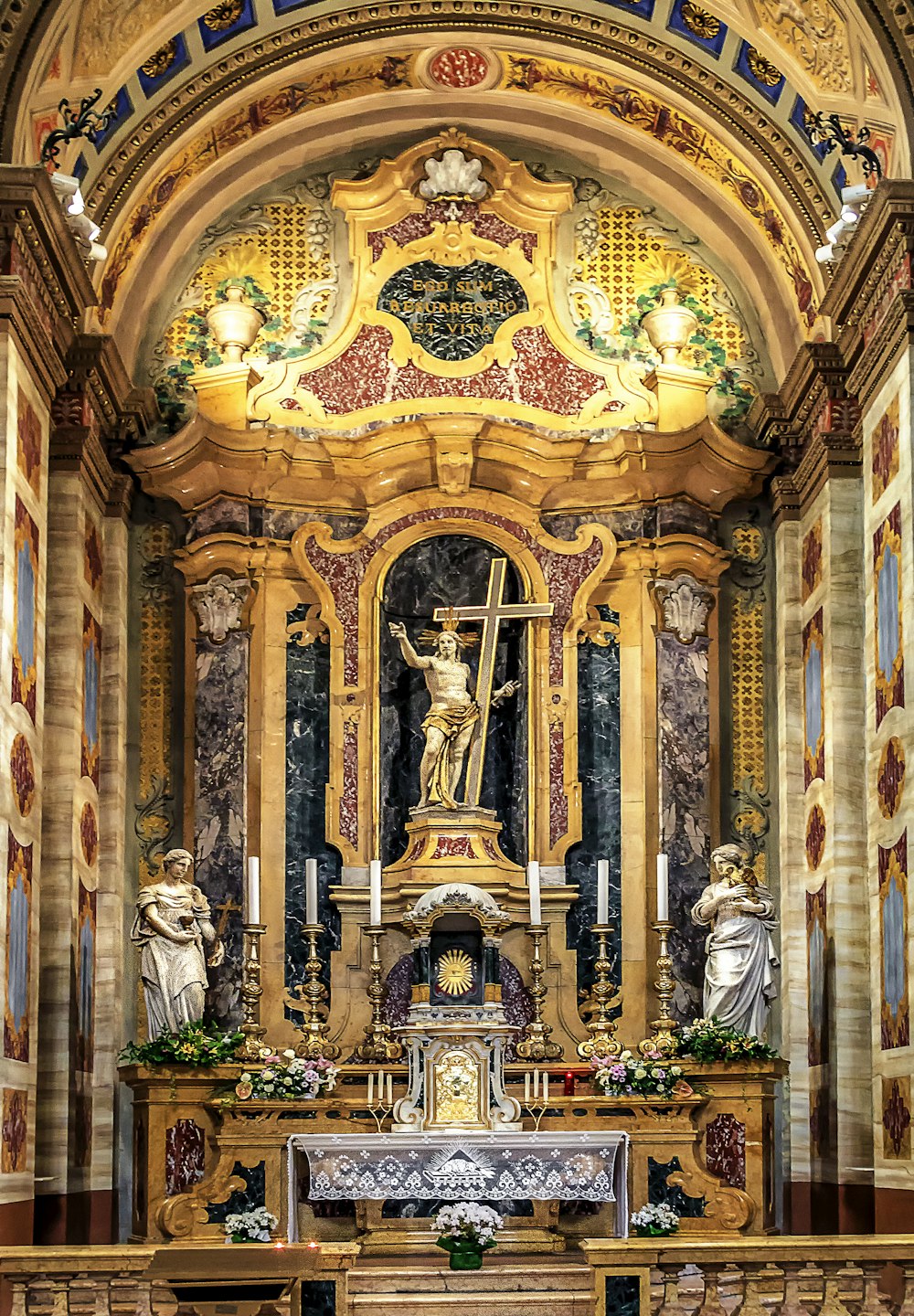 a church with a statue of jesus on the alter