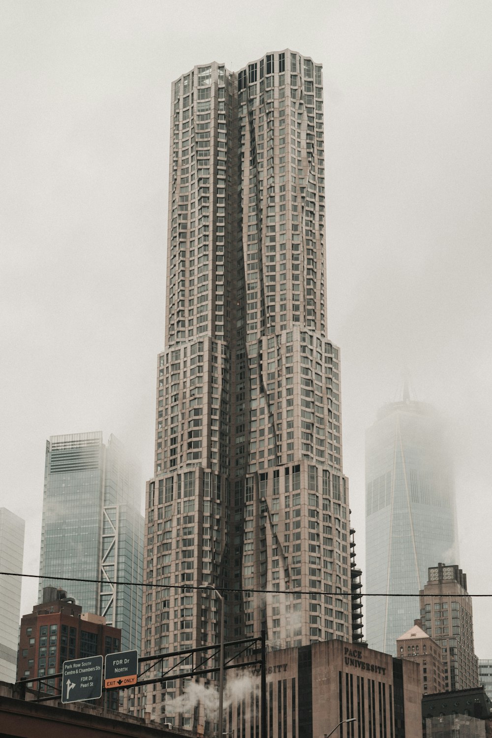 a very tall building towering over a city