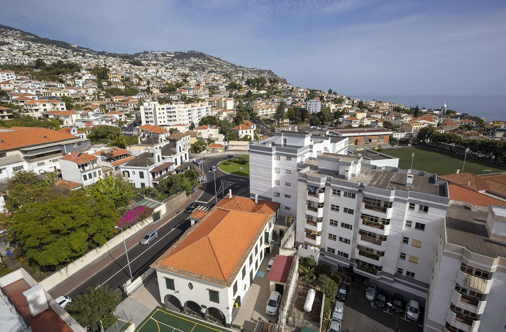 an aerial view of a city with a hill in the background