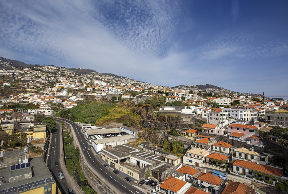 an aerial view of a city with a hill in the background