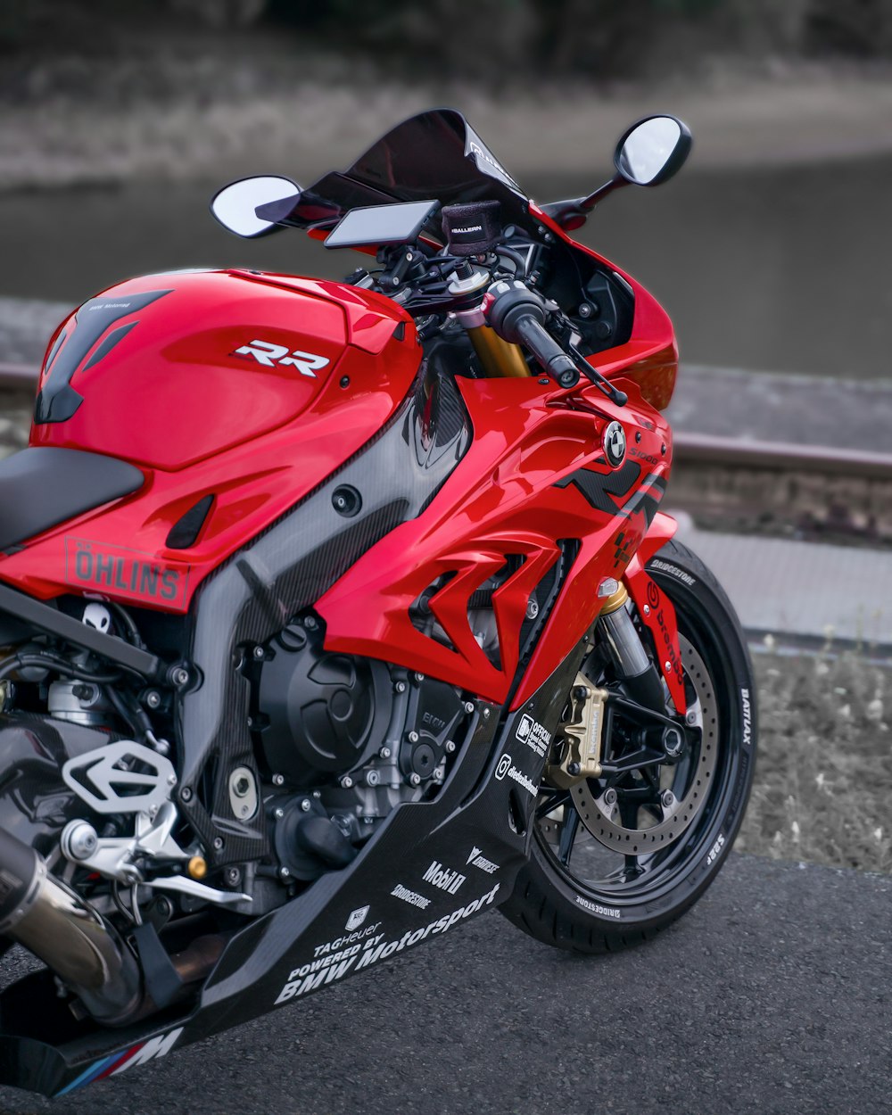 a red motorcycle parked on the side of a road