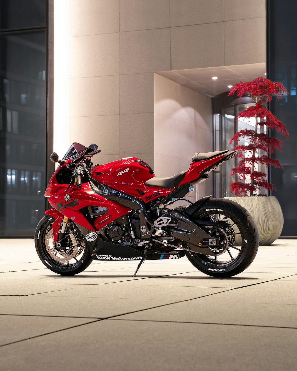 a red motorcycle parked in front of a building