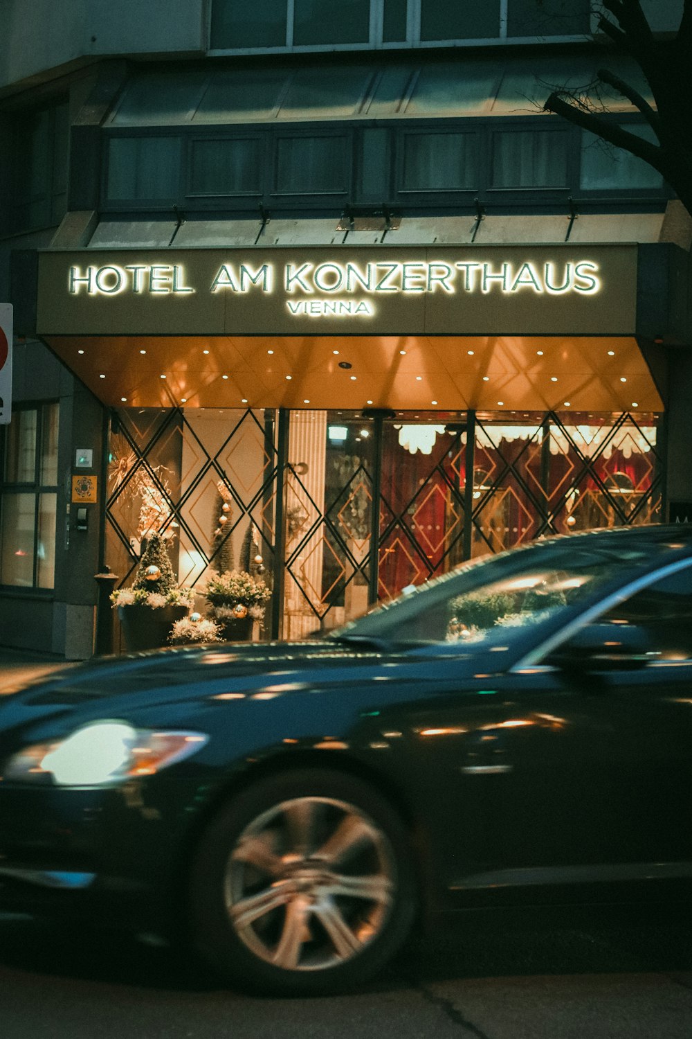 a car is parked in front of a hotel