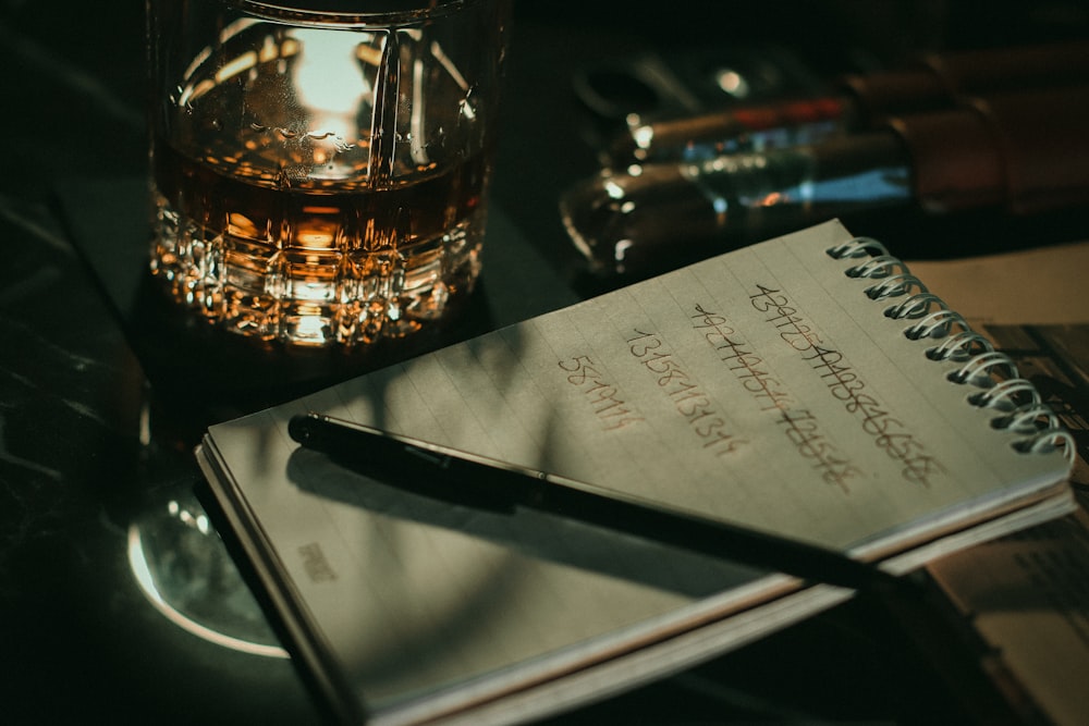 a notebook and pen sitting on top of a table