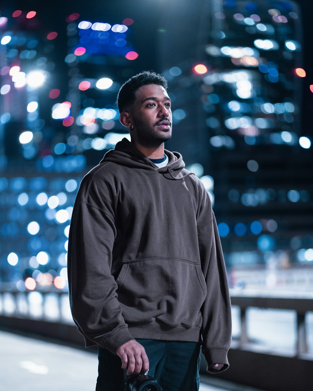 a man standing in front of a city at night