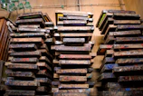 a large pile of wooden pallets sitting next to each other