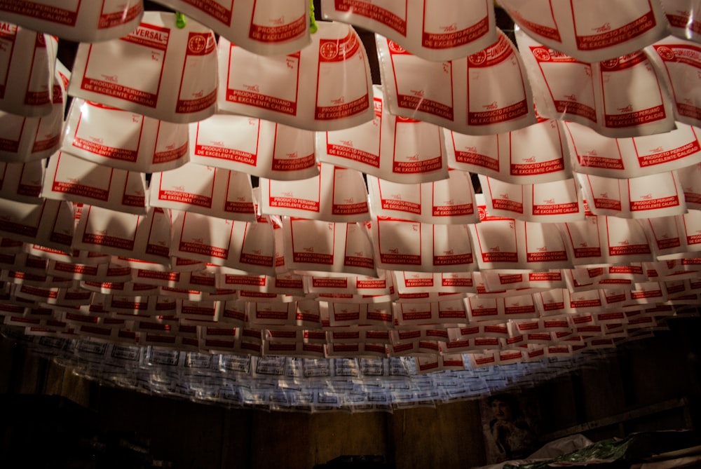 a room filled with lots of red and white bags