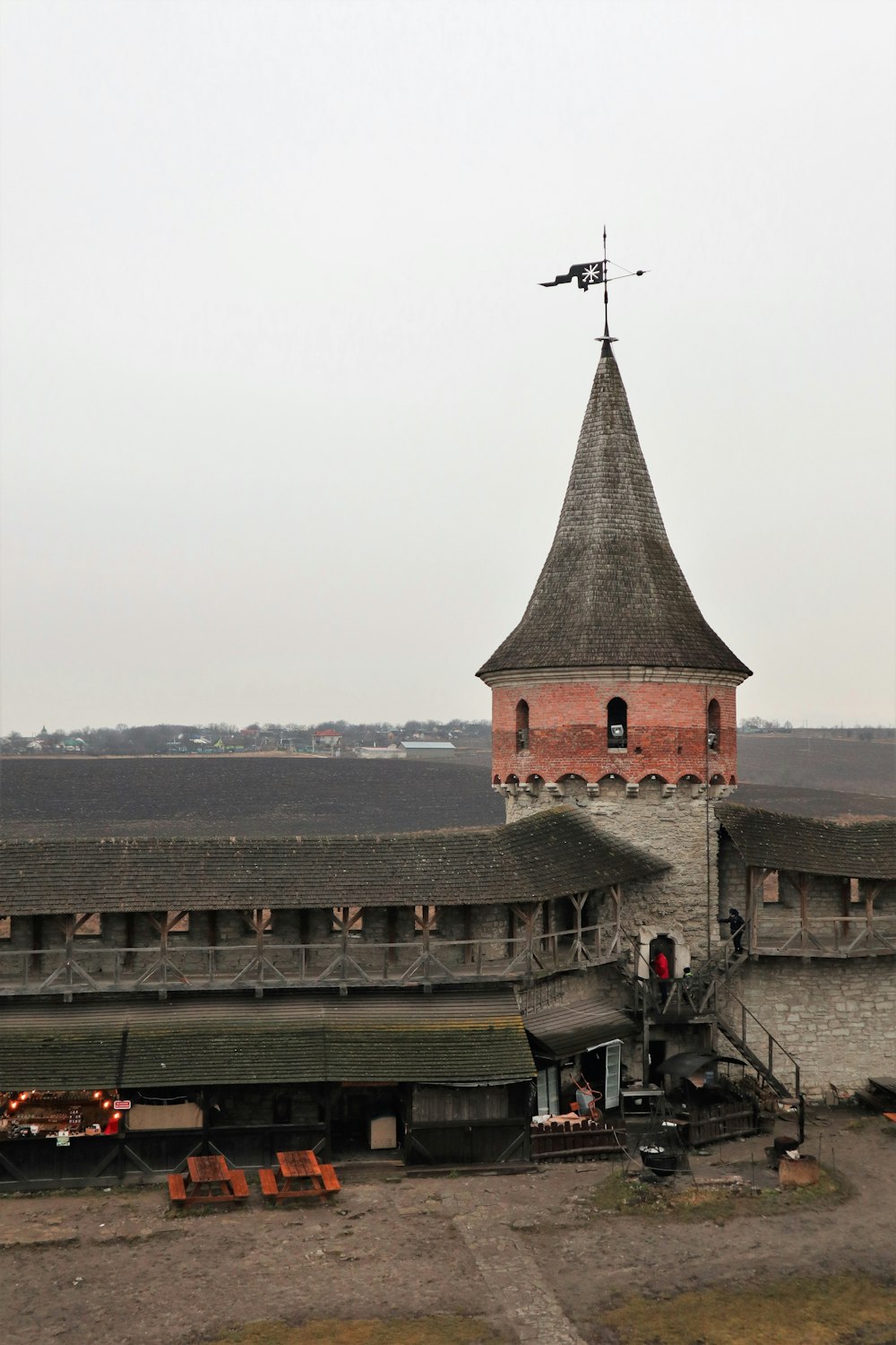 a tall tower with a weather vane on top of it