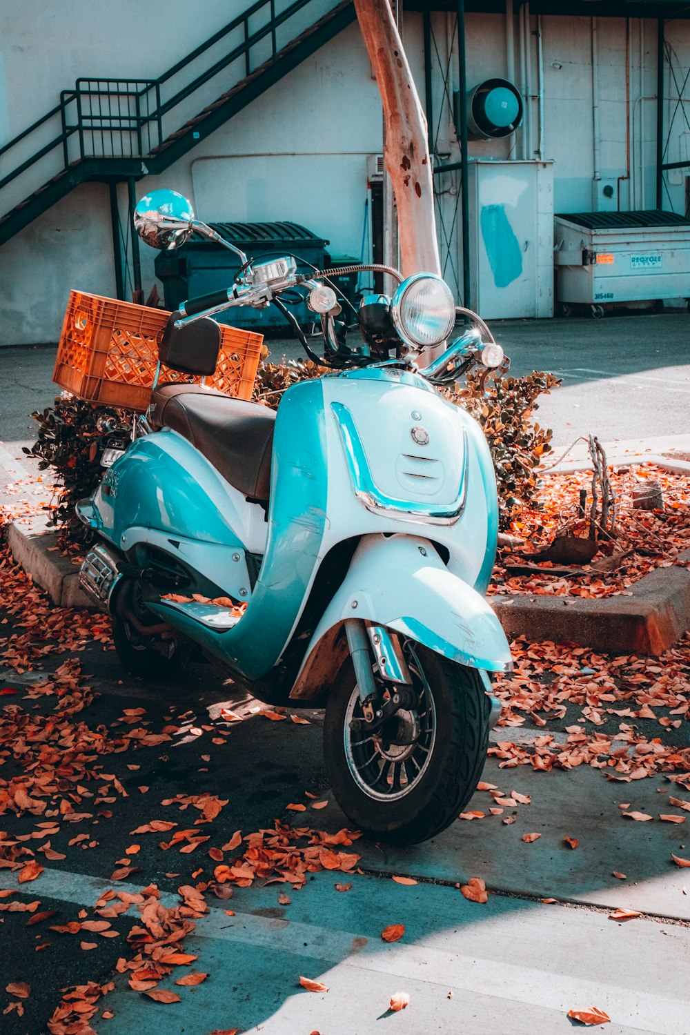 a blue scooter parked in front of a building
