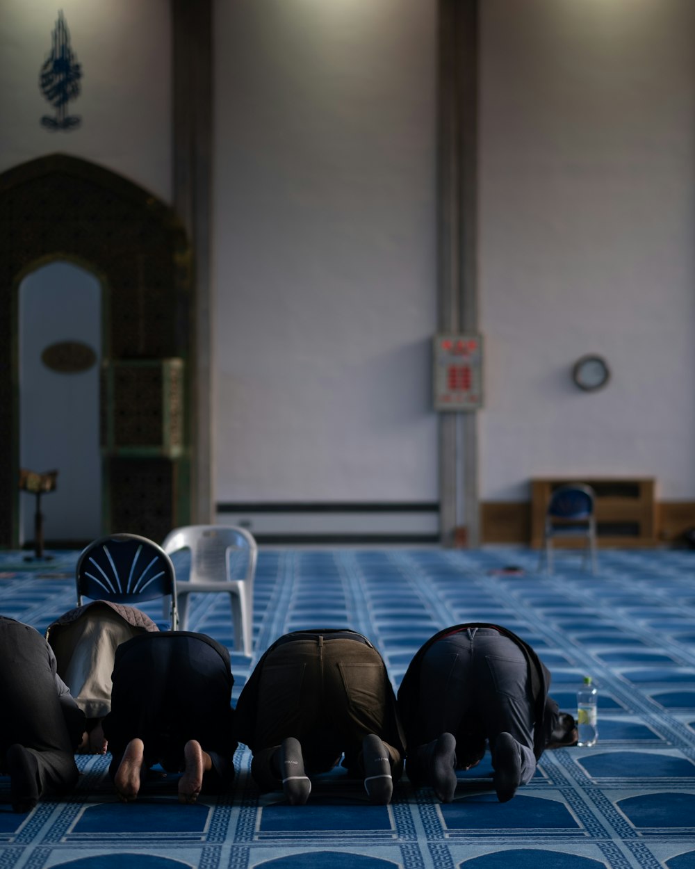 a group of people laying on top of a blue floor