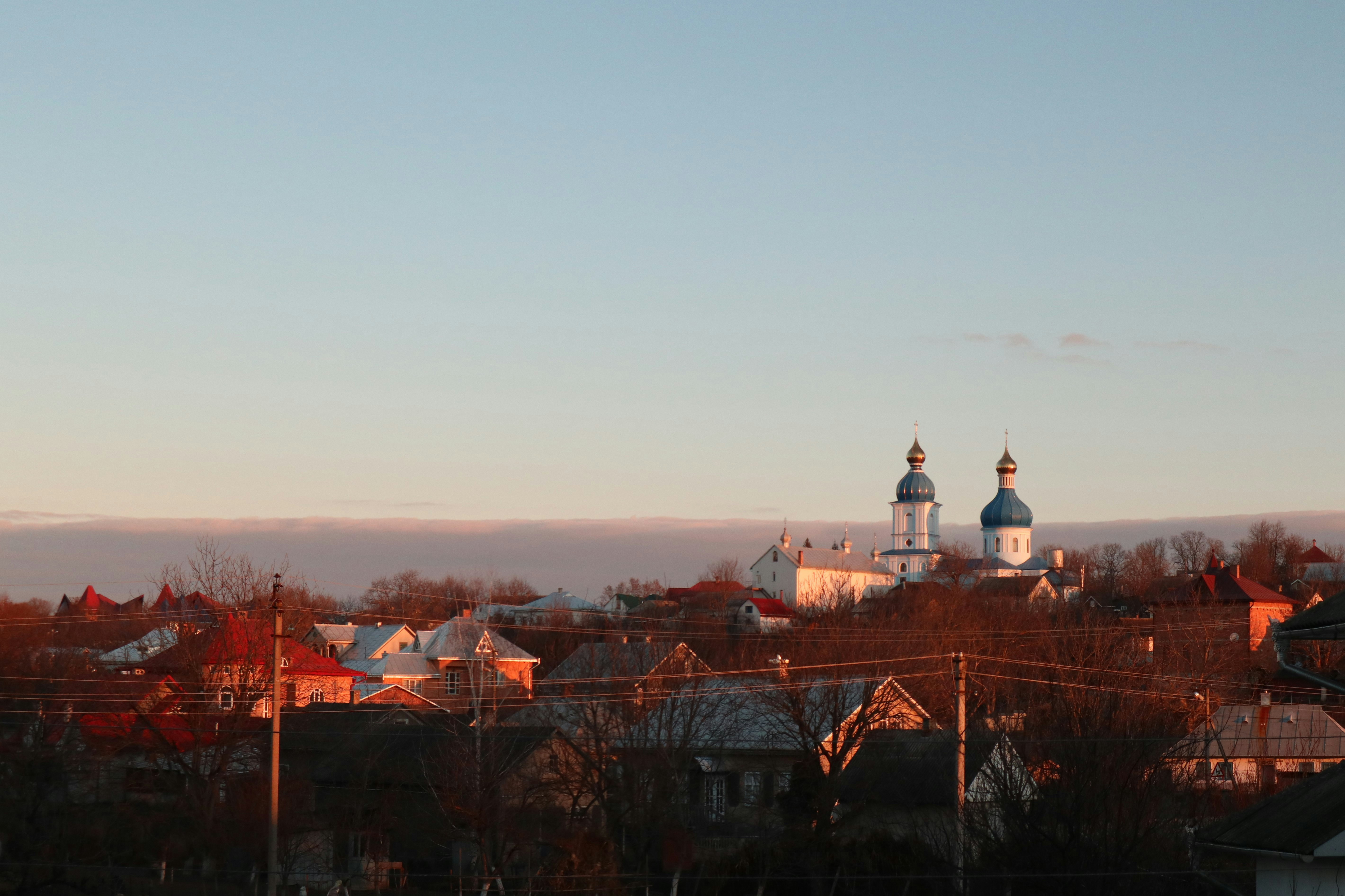a view of a town with a church in the background