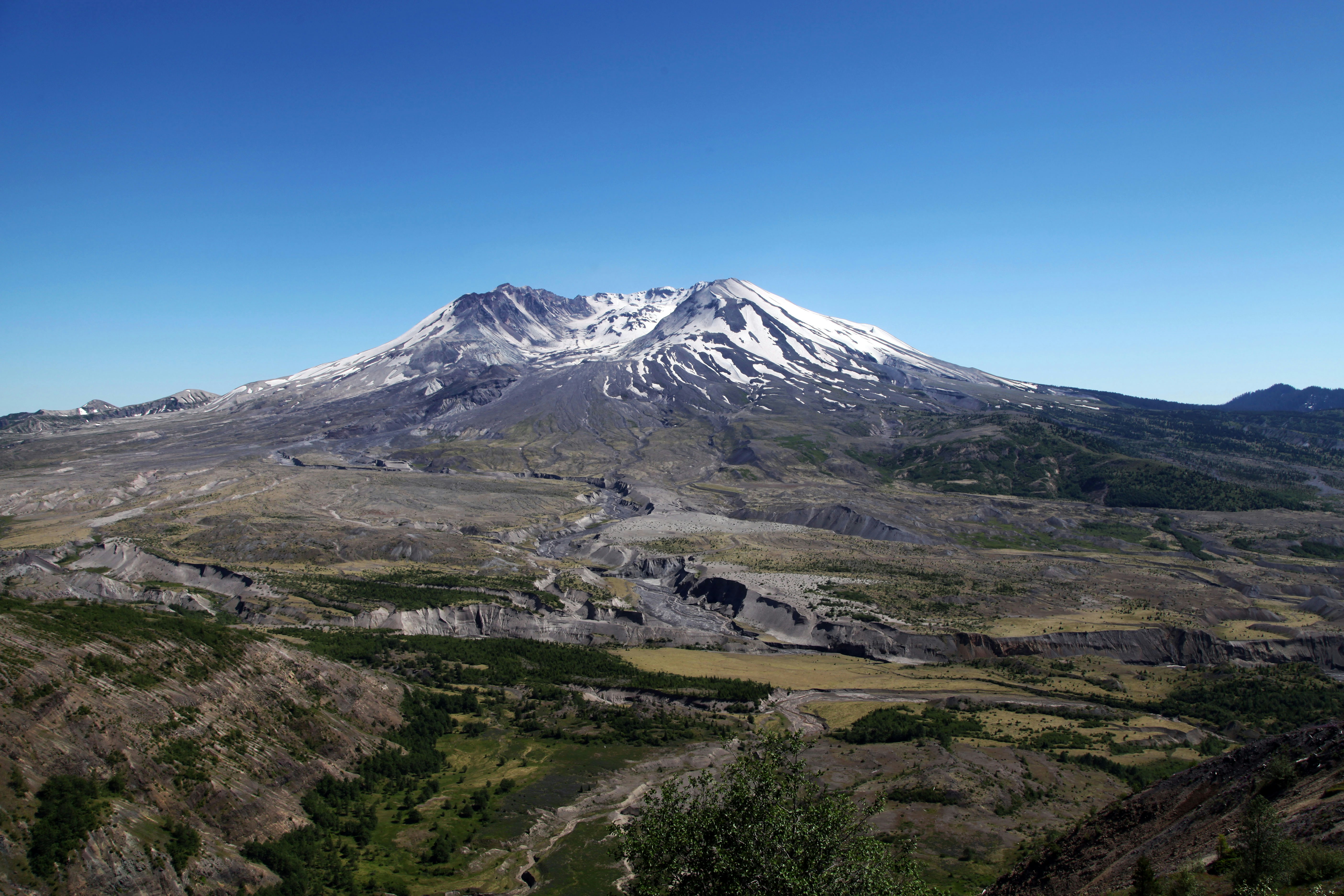 a view of a mountain with a snow capped peak