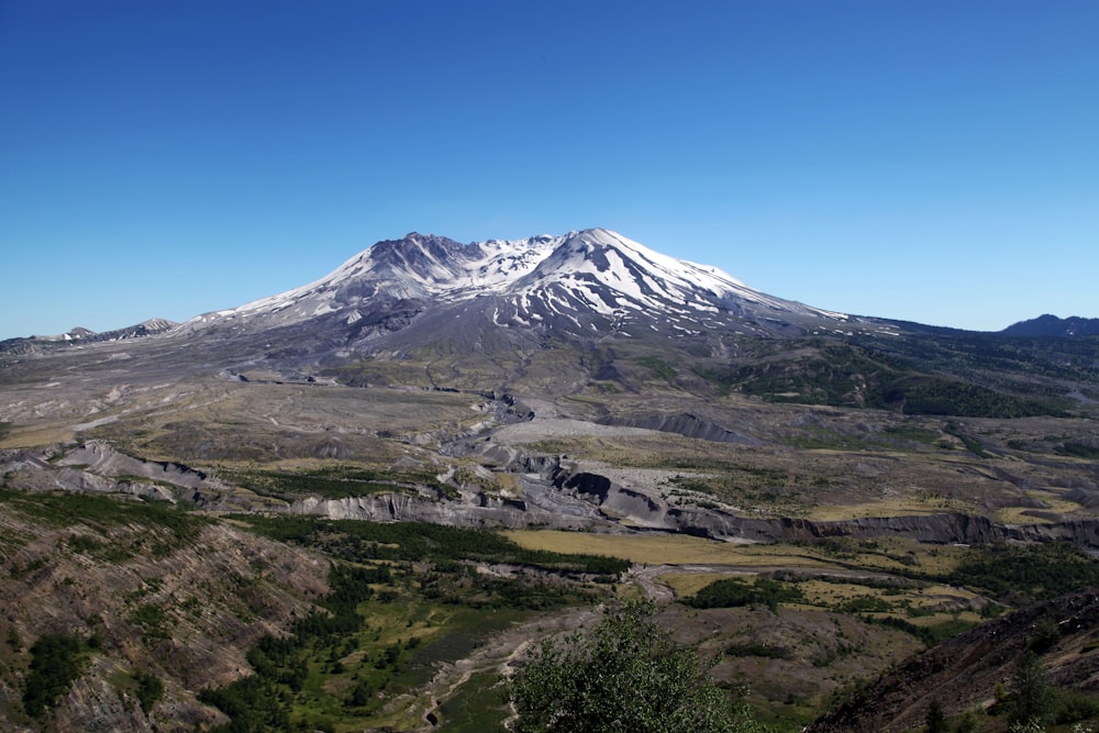 a view of a mountain with a snow capped peak