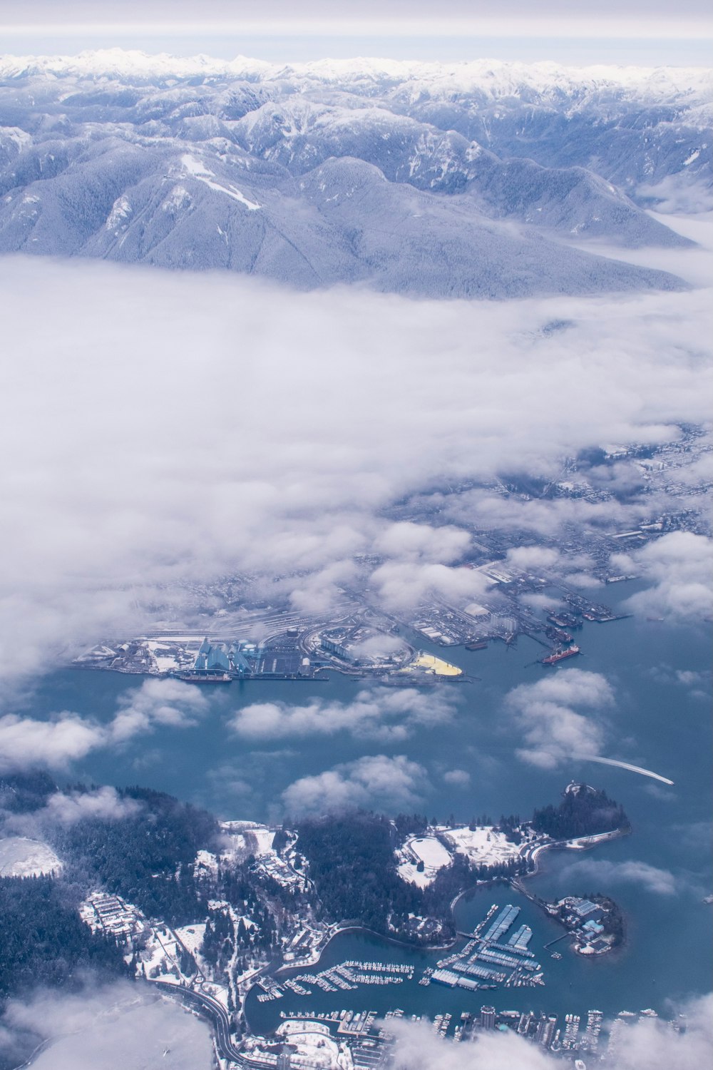 an aerial view of a large body of water surrounded by mountains