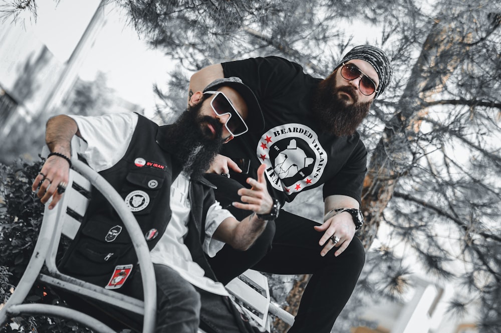two men with beards and sunglasses sitting next to each other