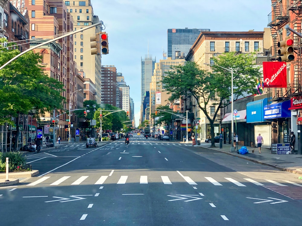 a city street with tall buildings and a traffic light