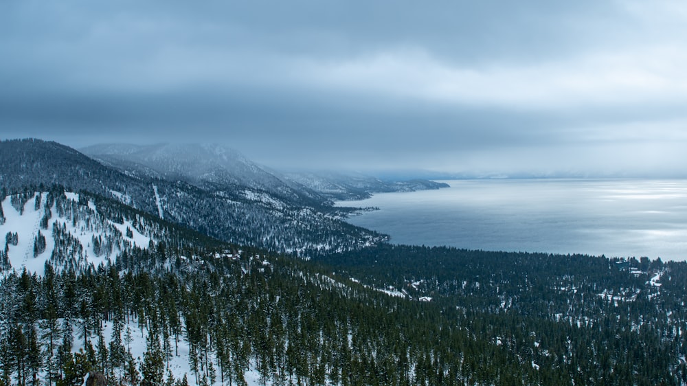 a view of a snowy mountain with a lake in the distance