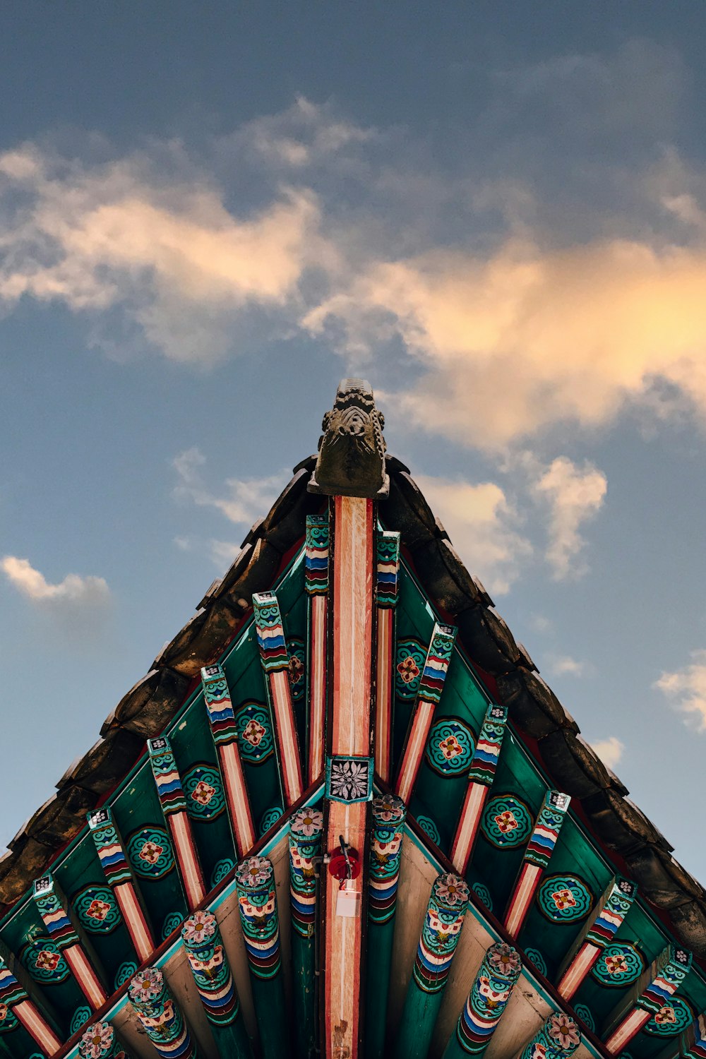 a close up of a building with a sky in the background