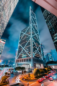 a very tall building towering over a city at night