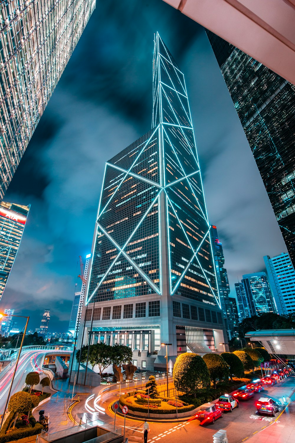 a very tall building towering over a city at night