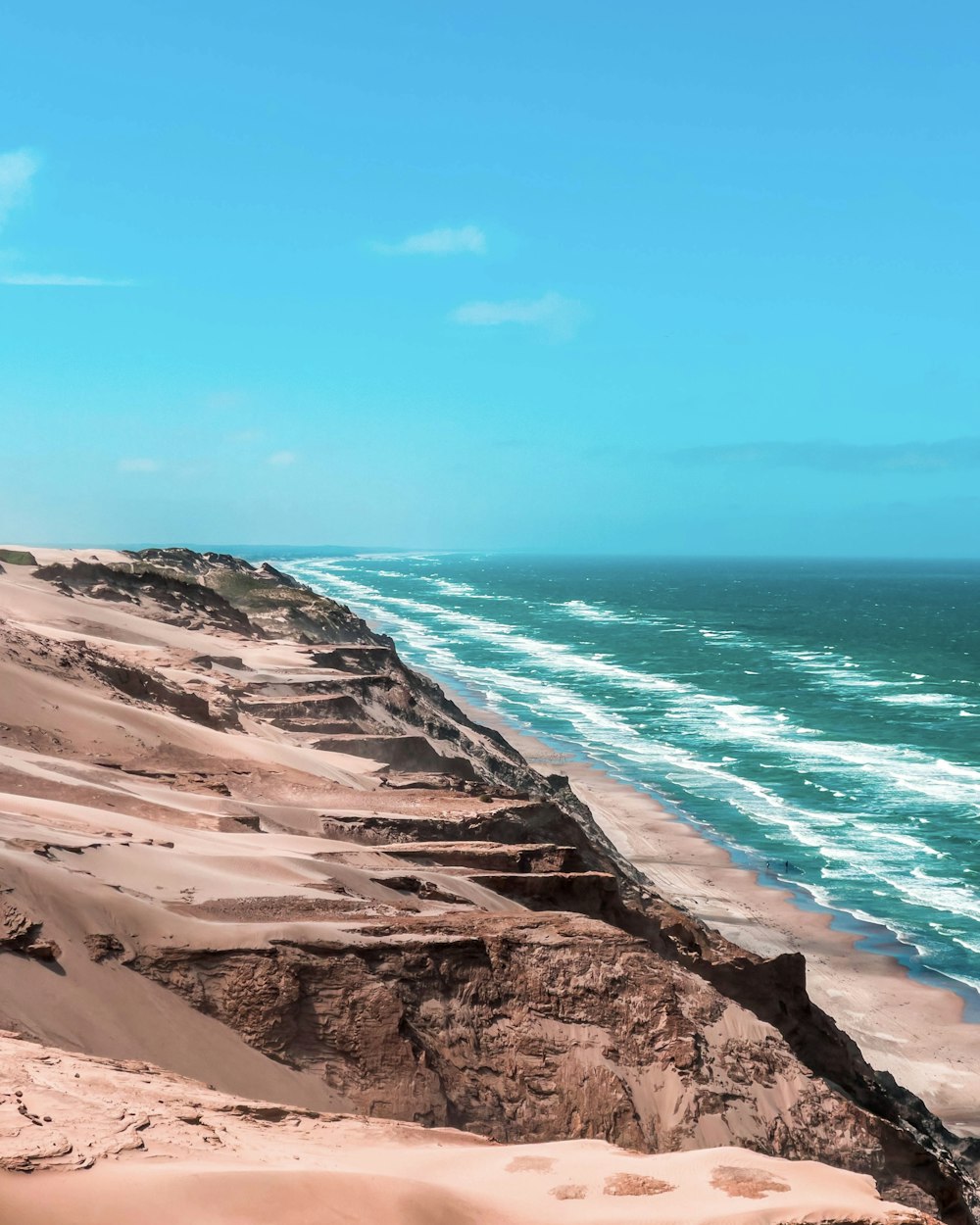 a view of the ocean from the top of a sand dune