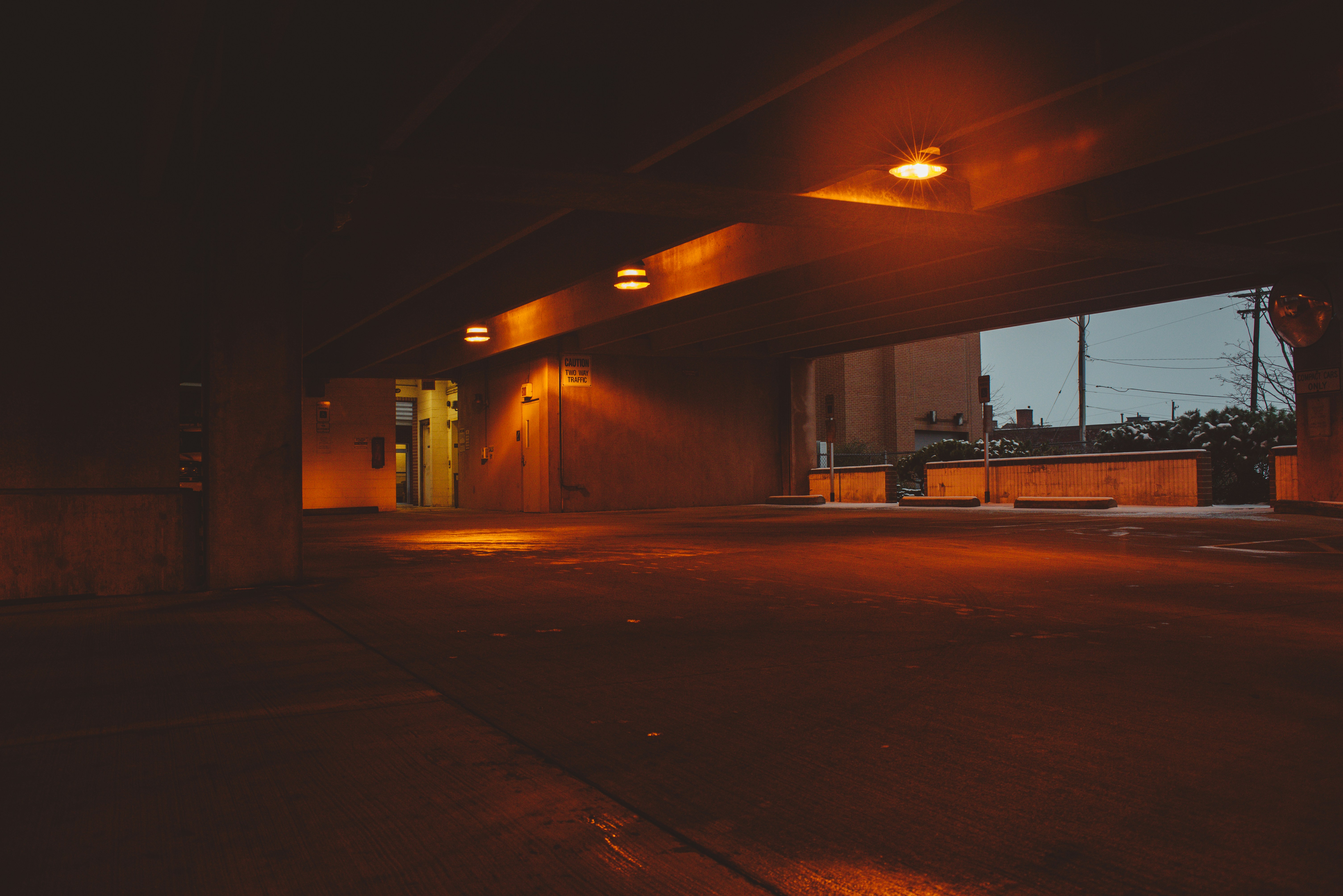 an empty parking garage at night with lights on