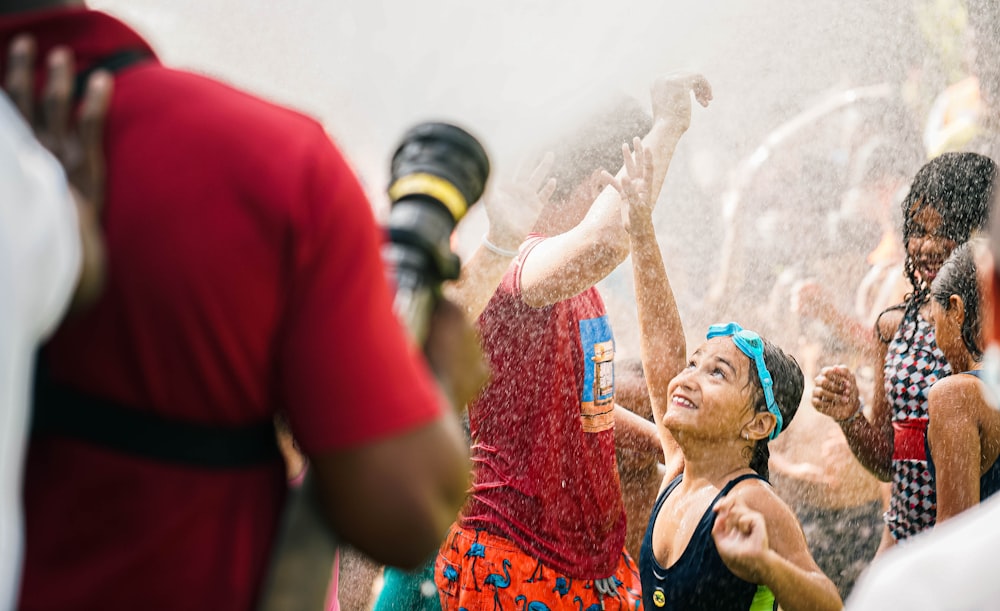 a group of people playing in a fountain